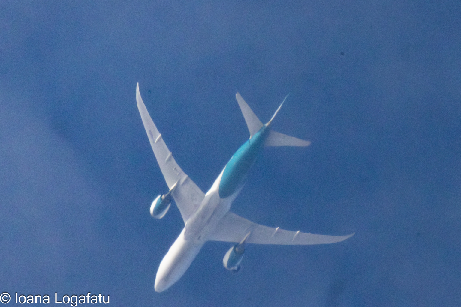 Airplane soaring above a cloud-covered sky